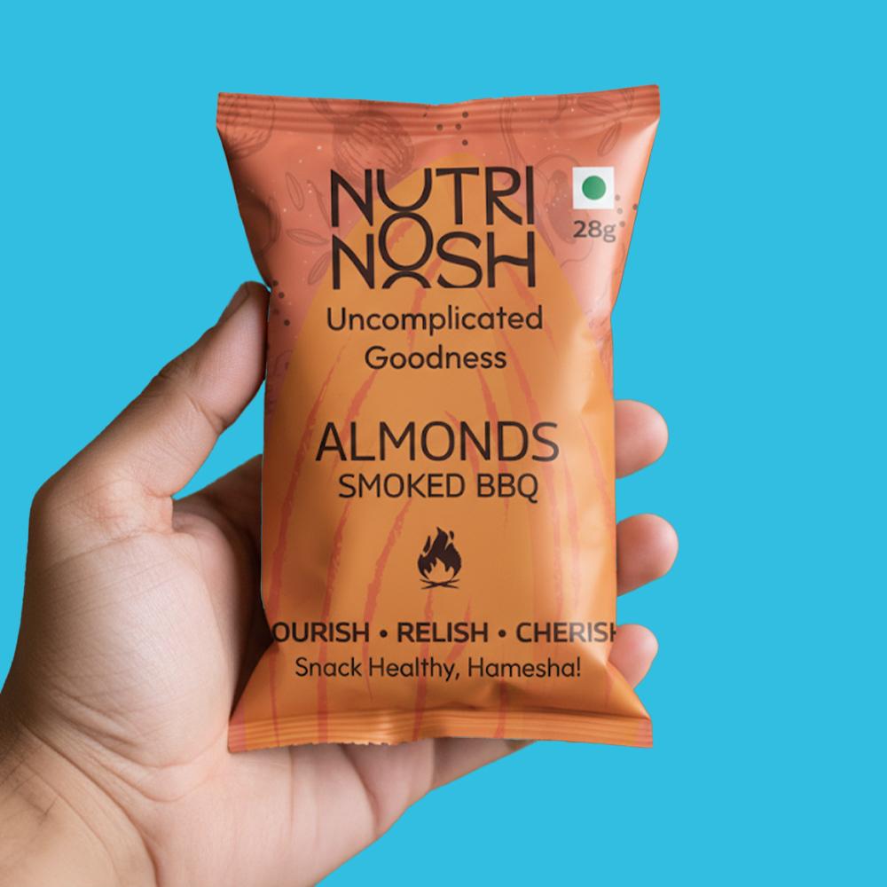 An Almonds Smoked BBQ 28g pack held in one hand